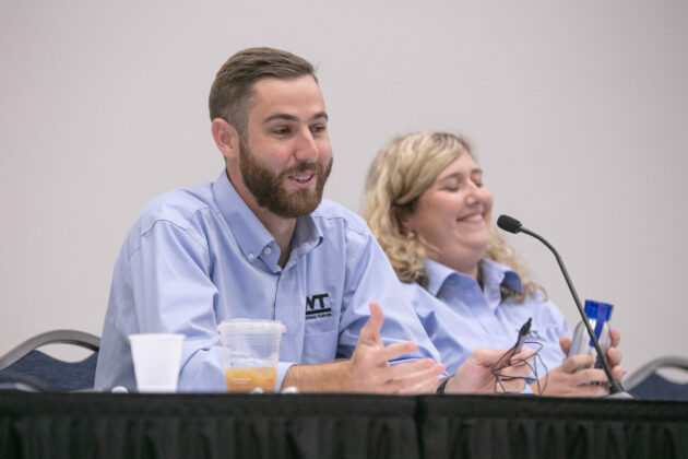two people in blue shirts having a discussion in a lean construction group