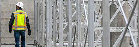 After receiving Lean learning for constructors, a construction worker observes the progress being made on a job site.